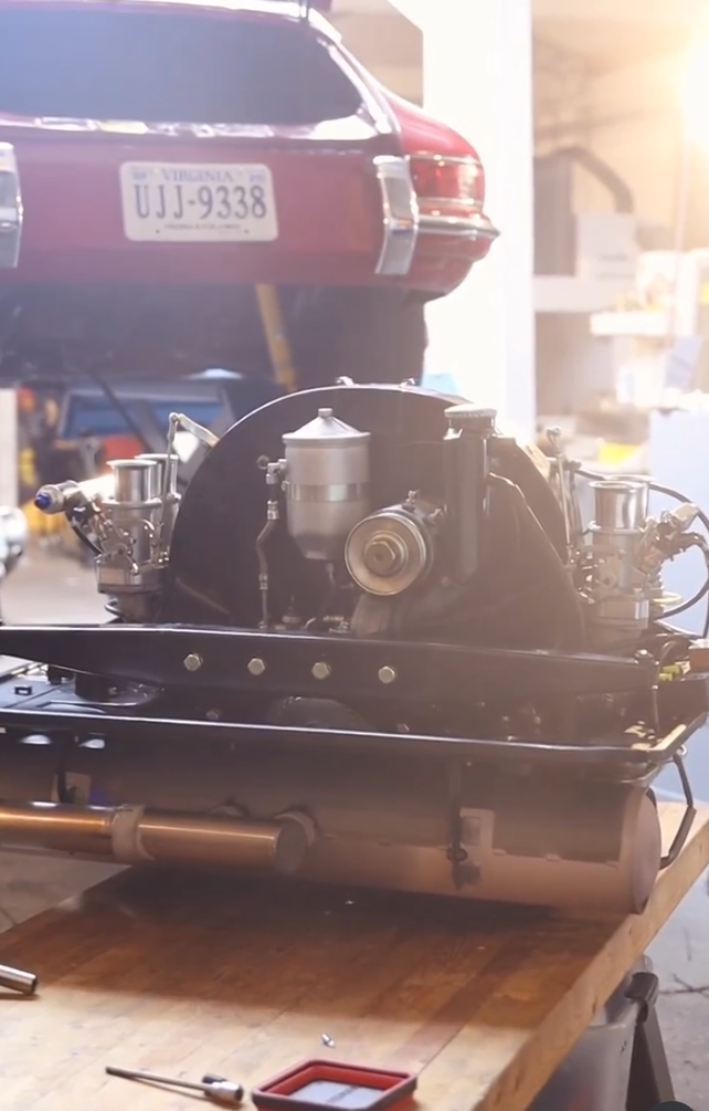 Vintage Porsche engine and components on a workshop bench