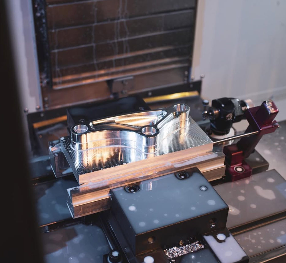 One-off metal component being machined in the shop